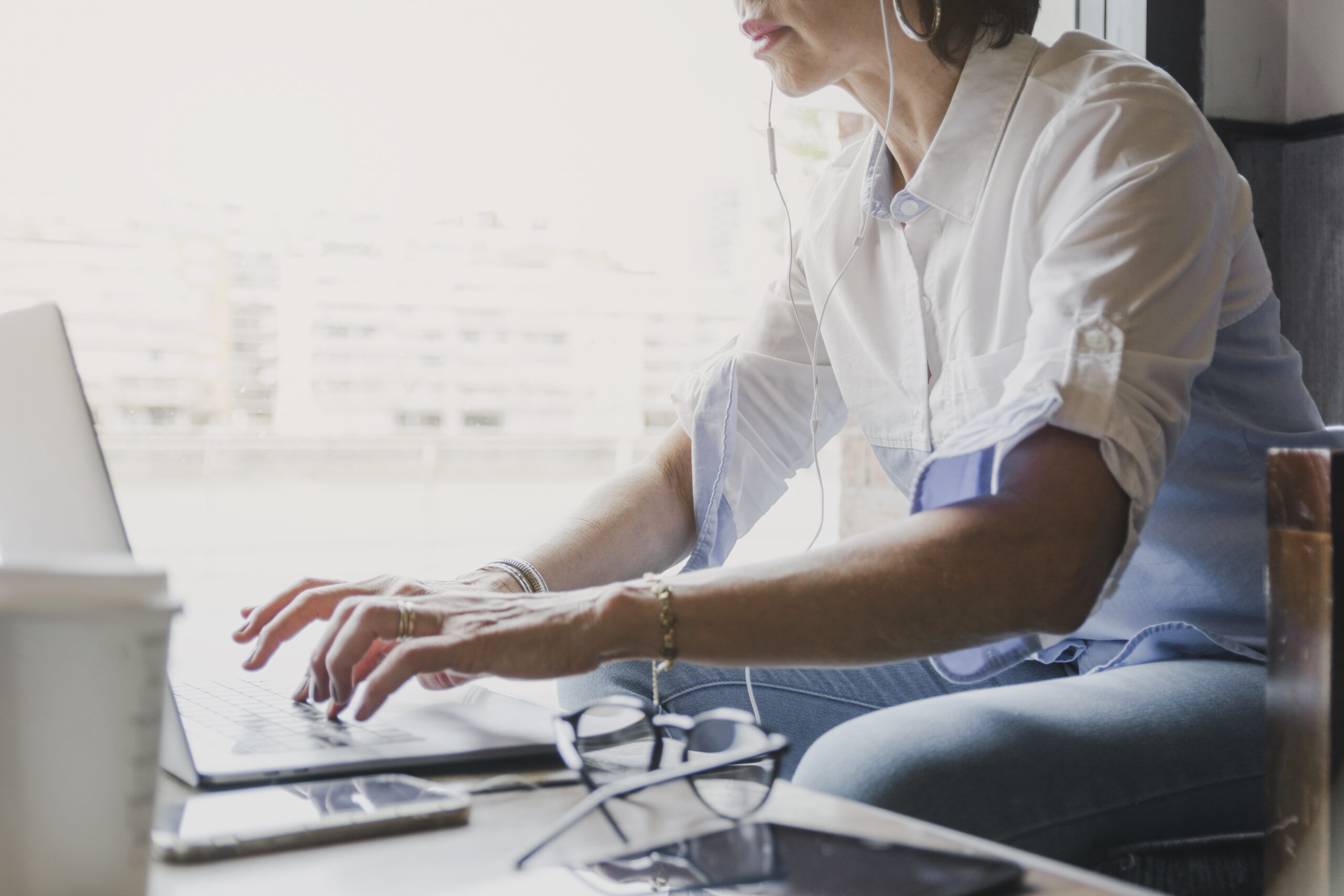 Woman typing laptop keyboard.