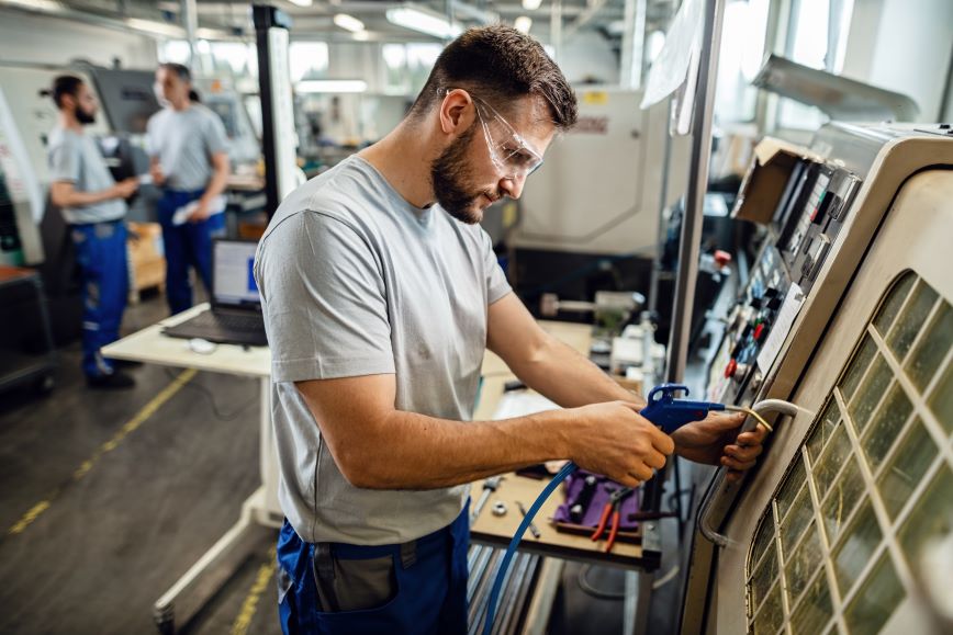 young-engineer-operating-cnc-machine-production-line-factory